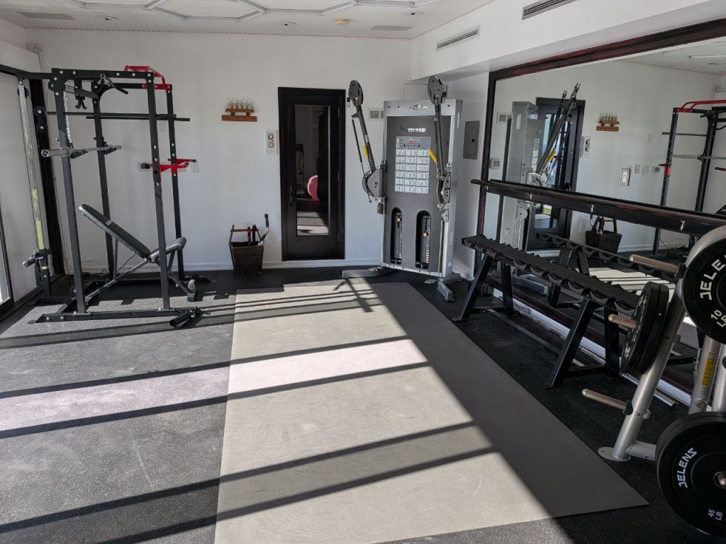 Freshly painted walls in home gym in Hollywood with mirror and fitness equipment