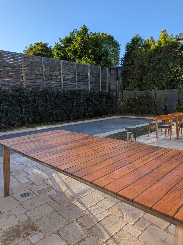 Restored outdoor wooden patio table after refinishing in Toluca Lake